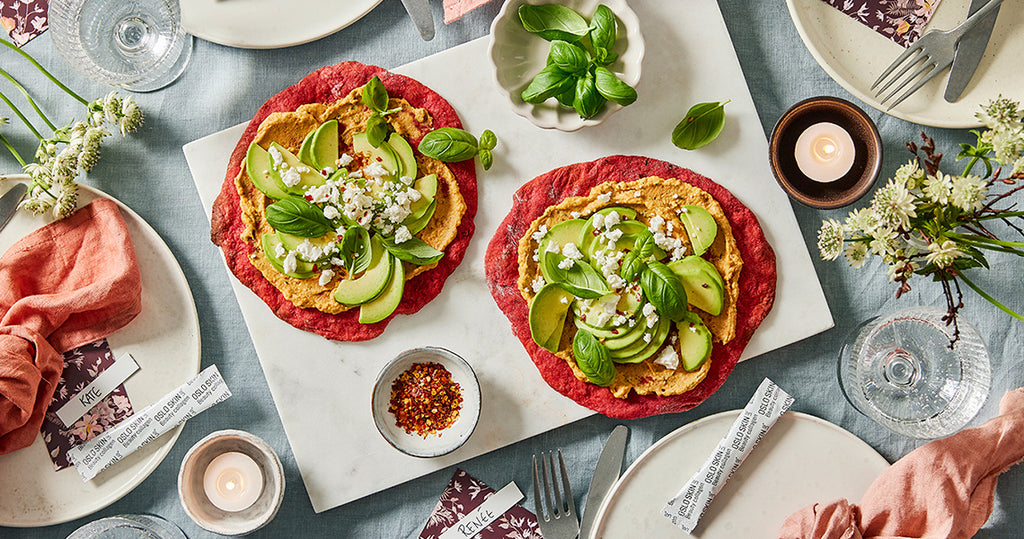 Beet pizza with sun dried tomatoes hummus and avocado